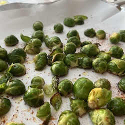 Tray of roasted brussel sprouts with olive oil and seasoning